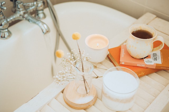 Pampering and relaxing bath with a cup of tea and book
