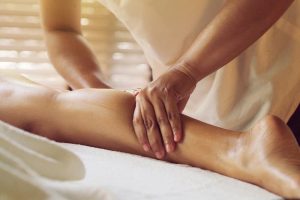 woman getting a leg massage in a beauty salon