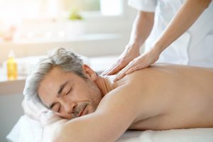 Man on a massage table having a shoulder massage